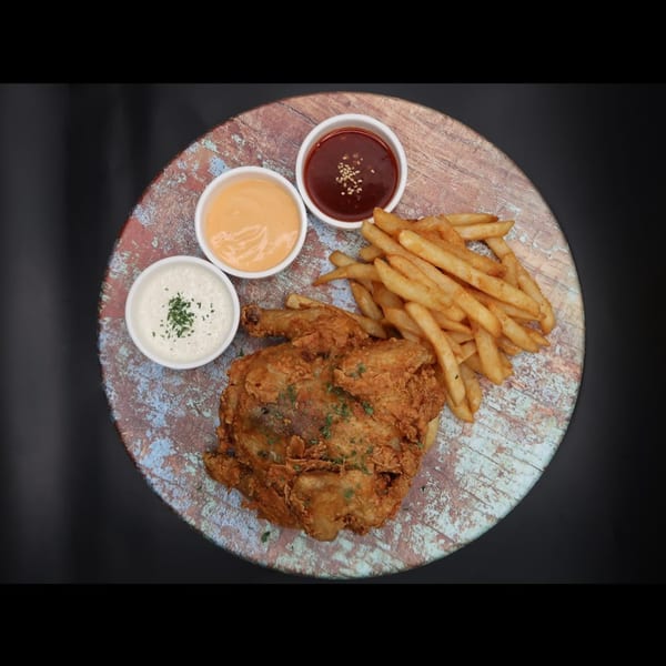 MOA Korean BBQ & Bar's fried chicken and french fries with three dipping sauces on a rustic wooden platter.