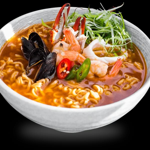 A bowl of MOA Korean BBQ & Bar's spicy seafood ramen with mussels, shrimp, crab, and scallions.