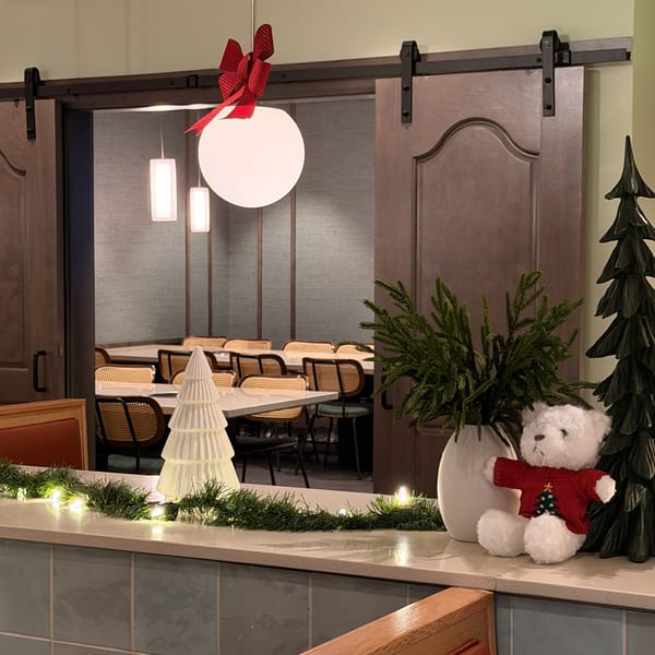 Christmas decorations on a counter with a dining room visible through an open barn door.